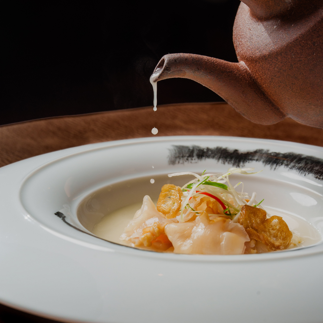 Poached geoduck in fresh fish rice broth